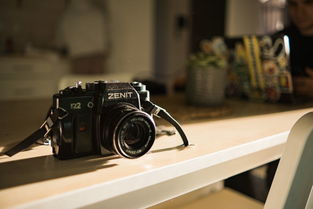 Filmmaking equipment including a camera and lenses arranged on a table