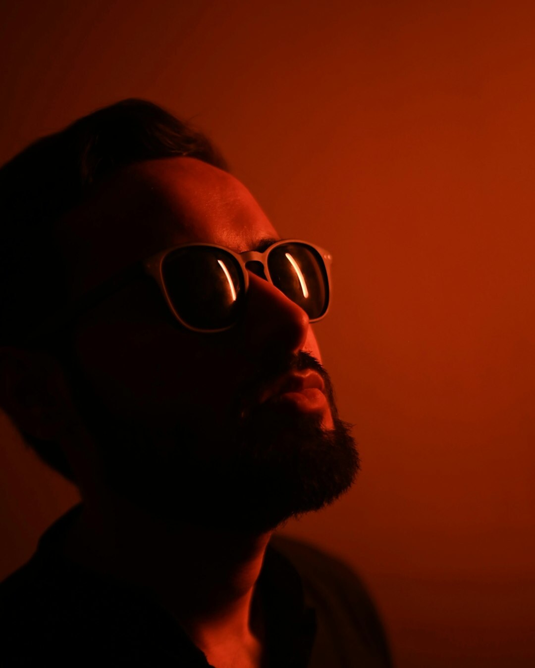 Studio portrait of a bearded man wearing glasses