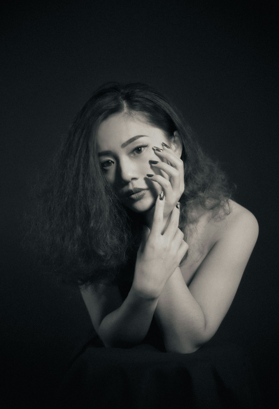 Studio portrait of a young woman with curly hair